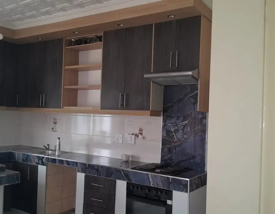 Two-tone oak and dark-oak kitchen with marble-look tops