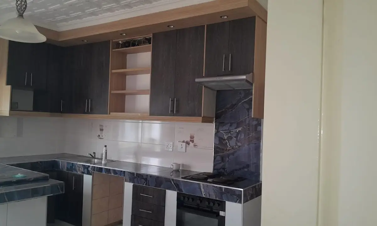 Two-tone oak and dark-oak kitchen with marble-look tops