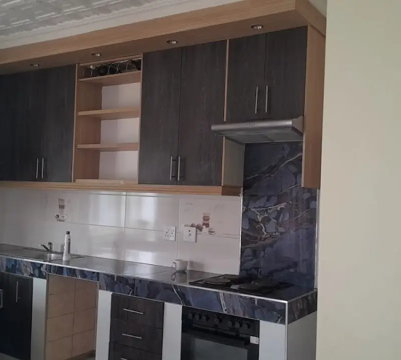 Two-tone oak and dark-oak kitchen with marble-look tops