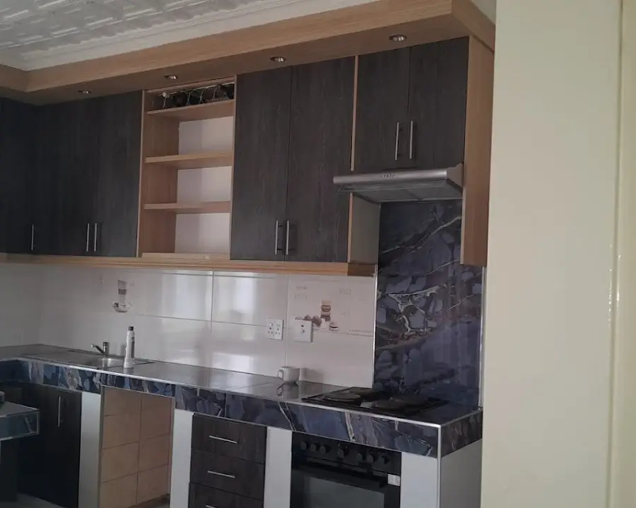 Two-tone oak kitchen with marble-look tops