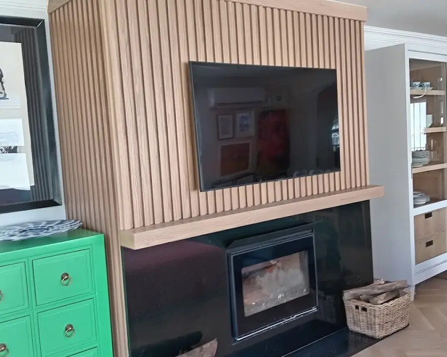 Oak-slat TV feature wall with fireplace and display cabinets